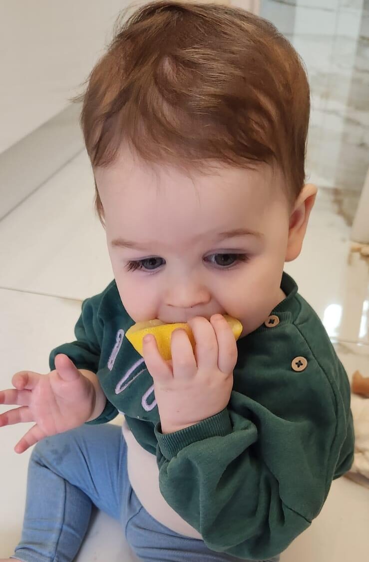 Why is Mendel Tifenbrun joyfully relishing the tangy zest of a lemon?